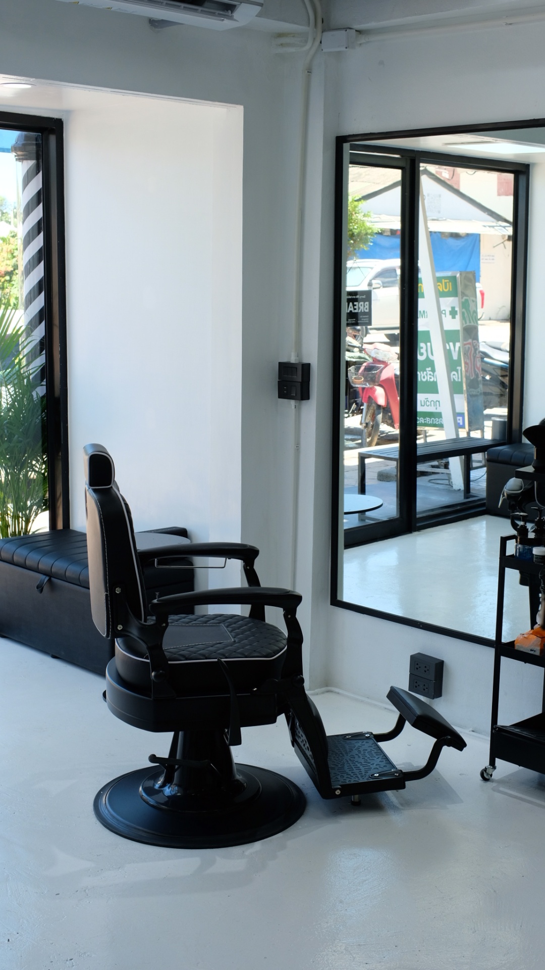 NextCut barbershop interior — barber chair, mirror and natural light